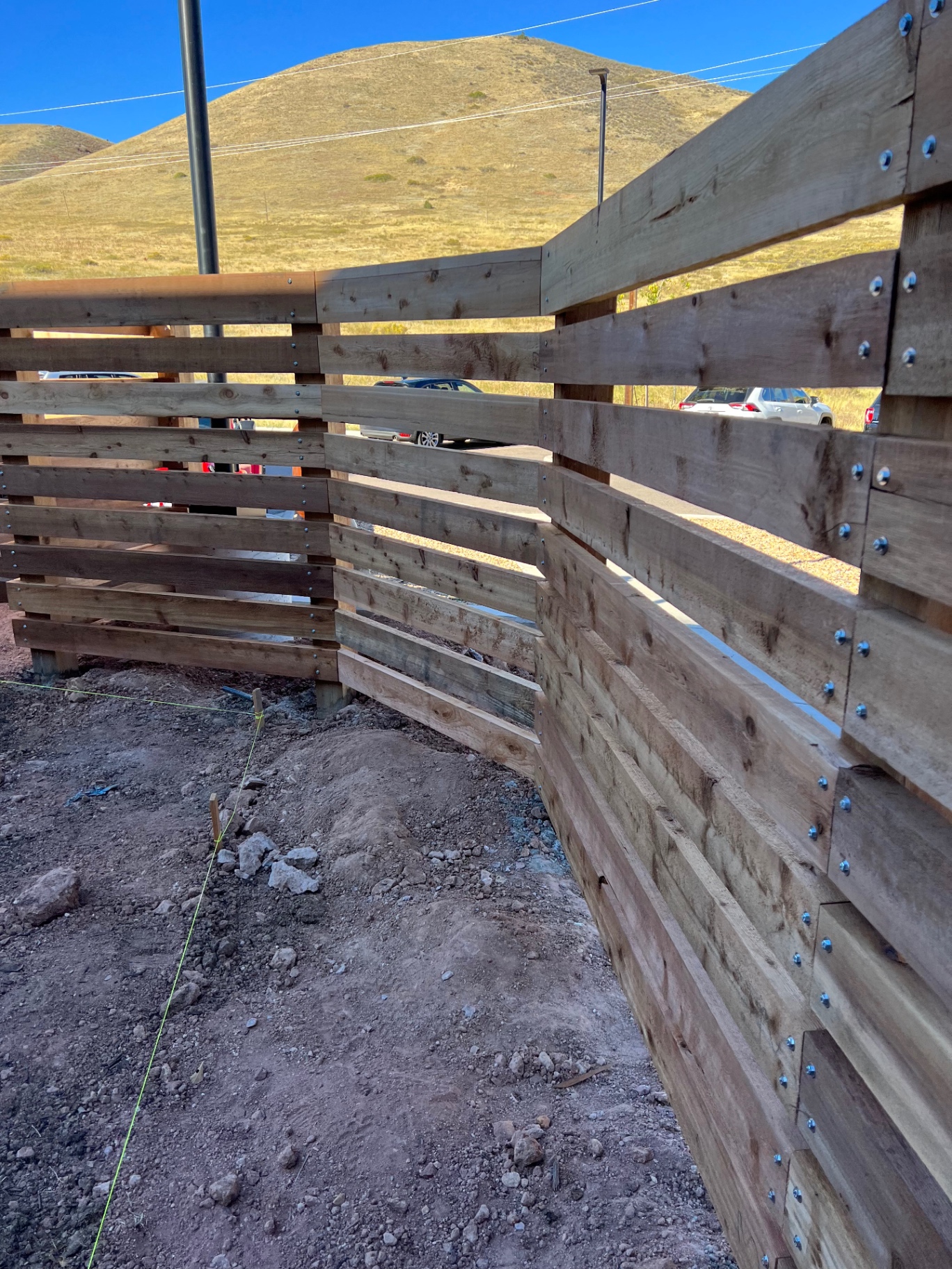 Custom horizontal wood fence stepped along a sloped property