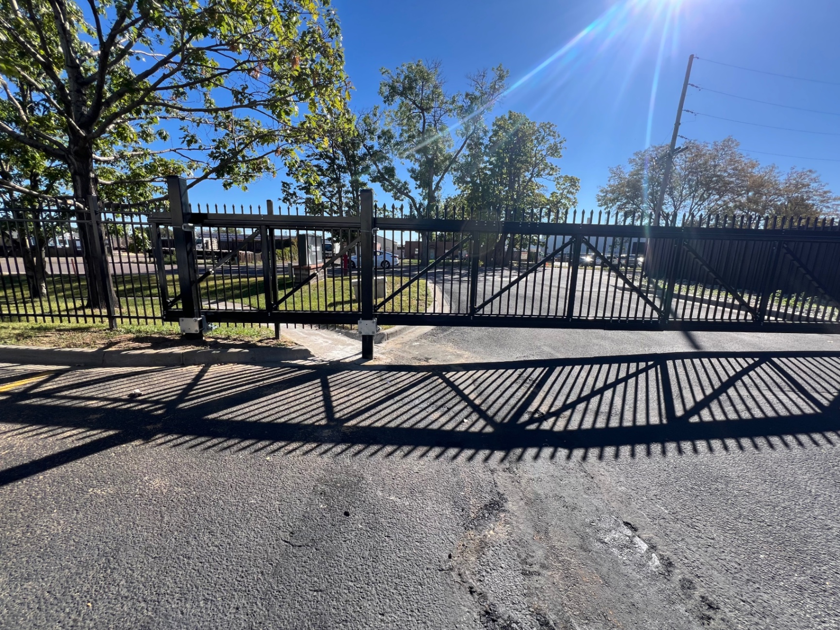 Black residential ornamental iron double drive gate with reinforced steel frames